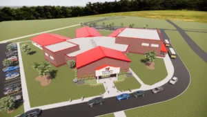 Rendering of new middle school by aerial view. School is brick with red roof and designed in a radial layout