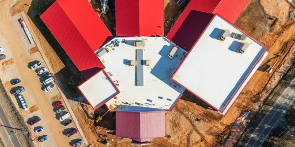 Aerial photo of the new middle school. Graphic shows red roof, and the school's radial layout