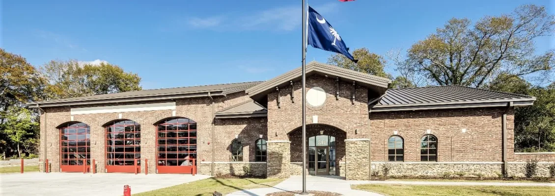 3-bay fire station with American flag and South Carolina state flag waving